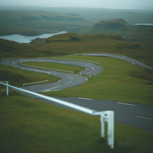 Winding road through green hills and lakes serpentine